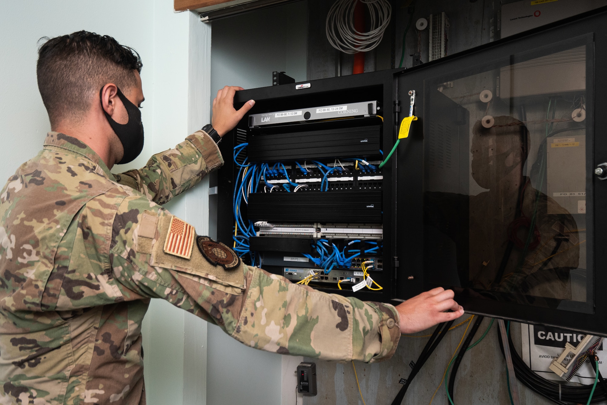 U.S. Air Force Tech. Sgt. Charles Chalk, a team chief nominee with the 202d Engineering Installation Squadron (EIS), 116th Air Control Wing, Georgia Air National Guard, inspects a data rack to verify there is room to install additional fiber optic cables during a large-scale communications infrastructure project at Muñiz Air National Guard Base, Puerto Rico, July 24, 2020. The 202d EIS is leading the project which includes multiple Air National Guard EIS units. The Airmen are relocating multiple communication systems’ cables and equipment to hardened facilities as part of the on-going recovery efforts in response to damage sustained during Hurricanes Irma and Maria. (U.S. Air National Guard photo by Senior Master Sgt. Roger Parsons)