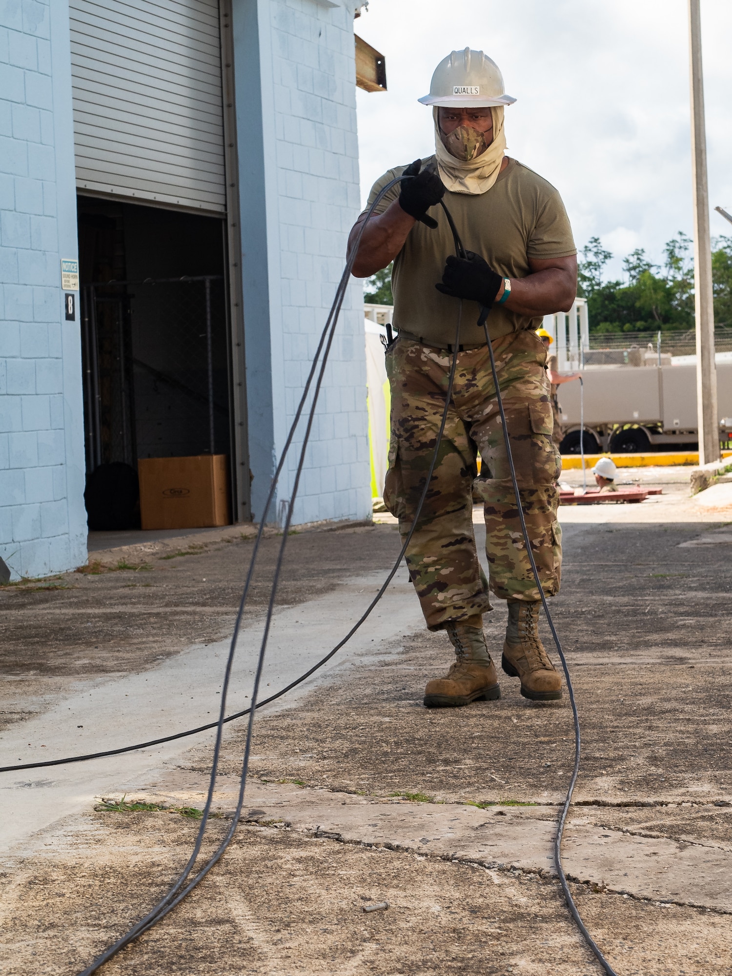 U.S. Air Force Tech. Sgt. Antonio Qualls, cable and antenna technician with the 202d Engineering Installation Squadron (EIS), 116th Air Control Wing, Georgia Air National Guard, prepares fiber optic cables for installation during a large-scale communications infrastructure project at Muñiz Air National Guard Base, Puerto Rico, July 22, 2020. The 202d EIS is leading the project which includes multiple Air National Guard EIS units. The Airmen are relocating multiple communication systems’ cables and equipment to hardened facilities as part of the on-going recovery efforts in response to damage sustained during Hurricanes Irma and Maria. (U.S. Air National Guard photo by Senior Master Sgt. Roger Parsons)