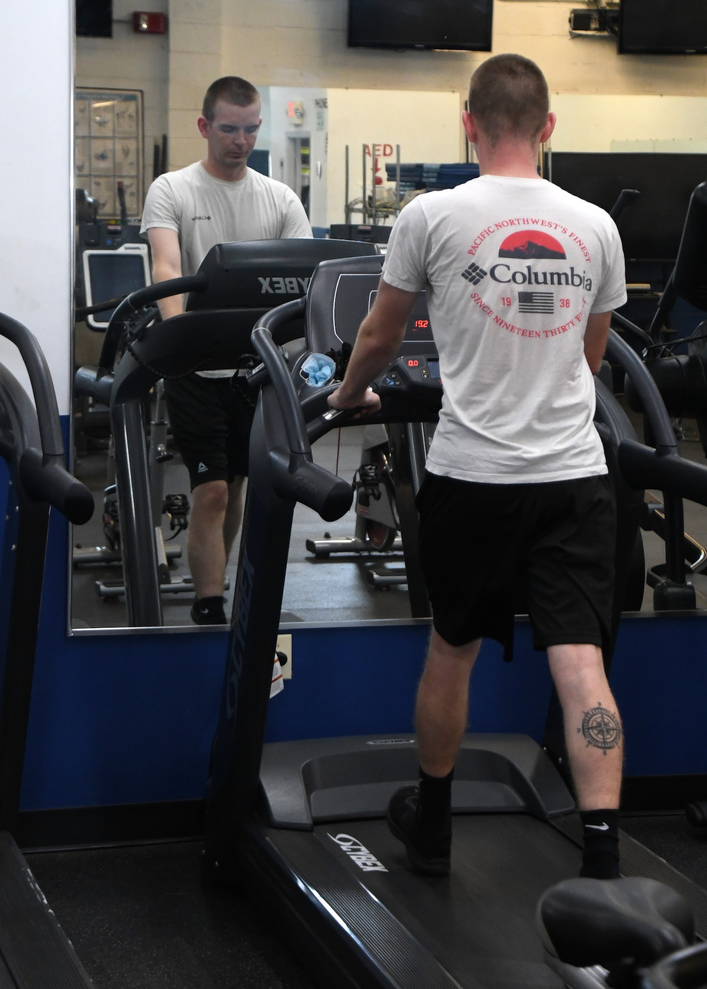 Senior Airman Brandon Ewing, 104th Fighter Wing Logistics Readiness Airman, walks on the treadmill in the base fitness room July 28, 2020, at Barnes Air National Guard Base, Massachusetts. Due to the COVID-19 pandemic, wing members who choose to work out need to sign in and follow stricter guidelines in order to maintain a safe and healthy environment.  (U.S. Air National Guard photo by Senior Airman Sara Kolinski)