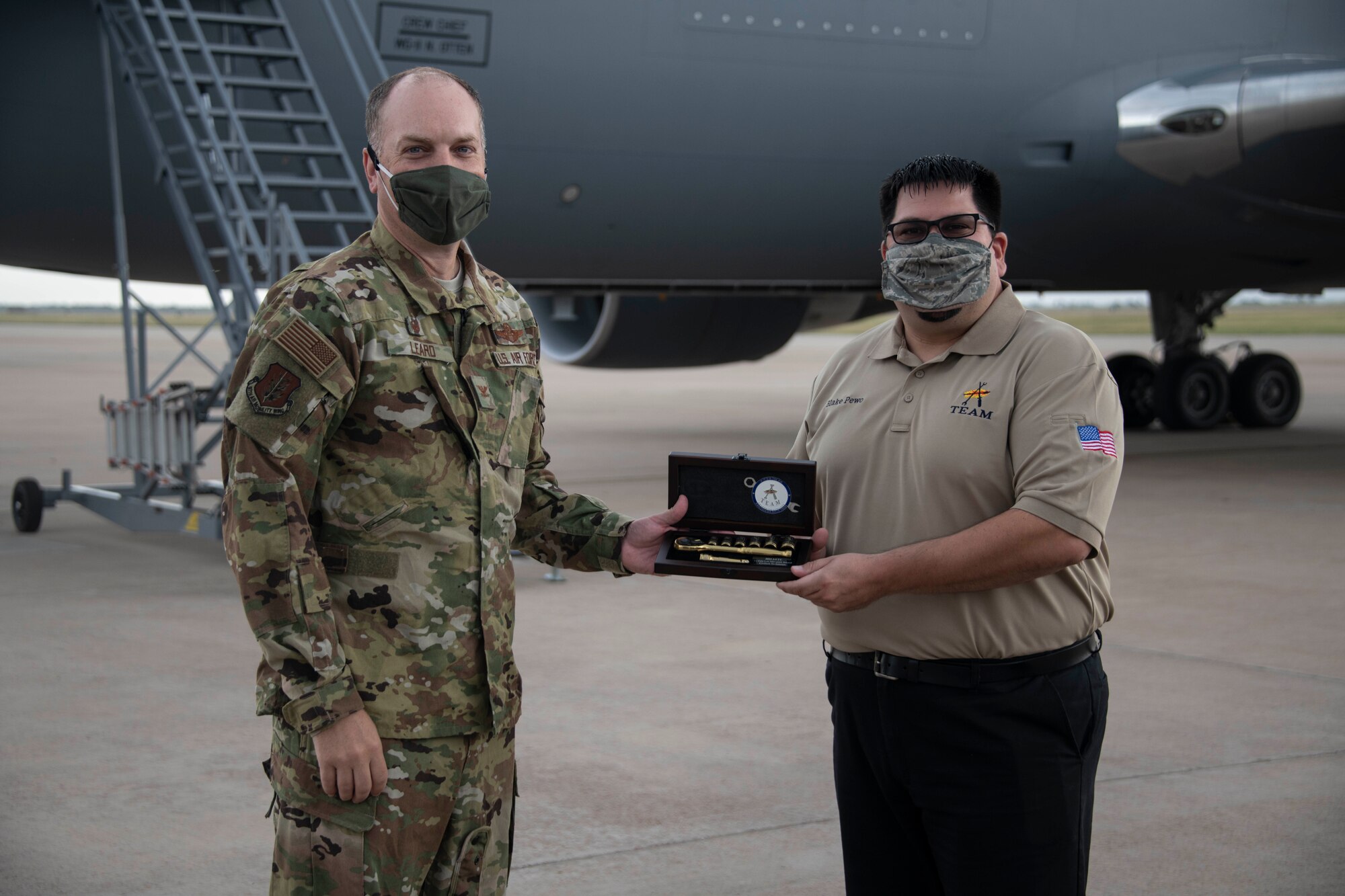 two people hold award