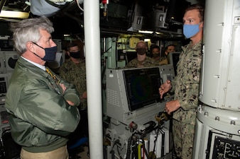Secretary of the Navy (SECNAV) Kenneth J. Braithwaite is briefed by Lt. j.g. Morgan Dejong aboard the Los Angeles-class attack submarine USS Hampton (SSN 767) during a tour.