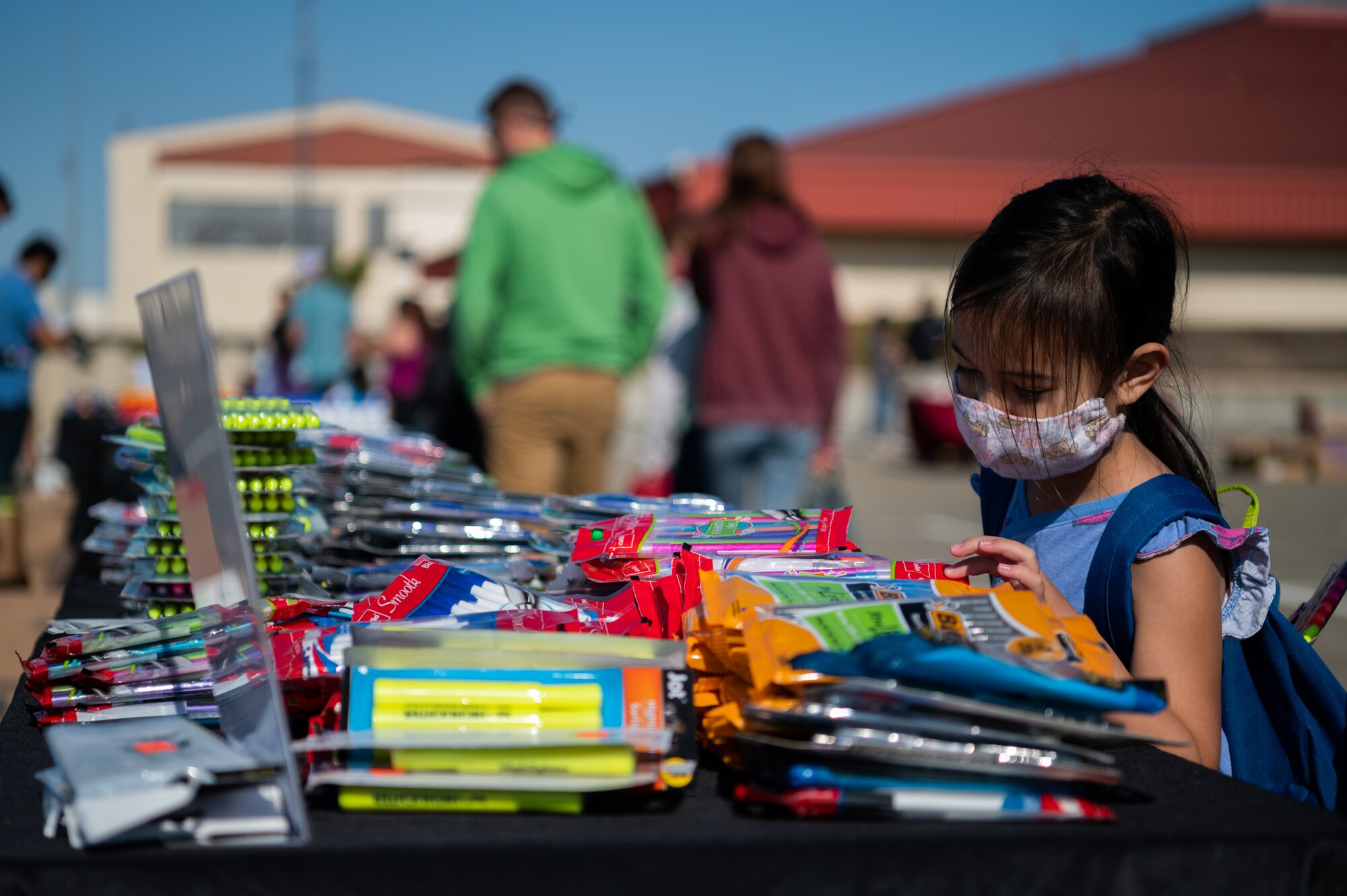 Military families receive back to school goods during an event.