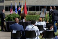 Brig. Gen. Mark S. Bennett, U.S. Army Financial Management Command commanding general, far left, presents a small version of the USAFMCOM flag to recently retired Sgt. Maj. Ronald Houston, U.S. Army Financial Management Command Operations senior enlisted advisor, far right, during Houston’s retirement ceremony at the Maj. Gen. Emmett J. Bean Federal Center in Indianapolis July 17, 2020. While the gift was presented by Bennett, it was from USAFMCOM’s employees in recognition of Houston’s more than 28 years of military service. (U.S. Army photo by Mark R. W. Orders-Woempner)