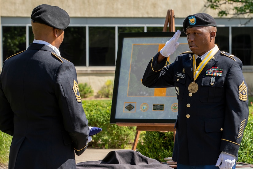 Recently retired Sgt. Maj. Ronald Houston, U.S. Army Financial Management Command Operations senior enlisted advisor, salutes the American flag as he an Master Sgt. L. Alphanzo Hunter take part in the “Old Glory” portion of Houston’s retirement ceremony at the Maj. Gen. Emmett J. Bean Federal Center in Indianapolis July 17, 2020. Houston was born and raised in New Orleans, Louisiana, and he joined the Army as a financial management specialist in May 1992, four days after graduating from high school. (U.S. Army photo by Mark R. W. Orders-Woempner)