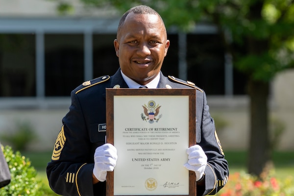 Recently retired Sgt. Maj. Ronald Houston, U.S. Army Financial Management Command Operations senior enlisted advisor, smiles as he holds his certificate of retirement from the U.S. Army at the Maj. Gen. Emmett J. Bean Federal Center in Indianapolis July 17, 2020. Houston was born and raised in New Orleans, Louisiana, and he joined the Army as a financial management specialist in May 1992, four days after graduating from high school. (U.S. Army photo by Mark R. W. Orders-Woempner)