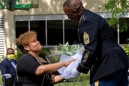 Sgt. Maj. Ronald Houston, U.S. Army Financial Management Command Operations senior enlisted advisor, presents flowers to his wife, Shani Adams-Houston, during his retirement ceremony at the Maj. Gen. Emmett J. Bean Federal Center in Indianapolis July 17, 2020. Sergeant Major Houston retired from the Army after more than 28 years of military service. (U.S. Army photo by Mark R. W. Orders-Woempner)