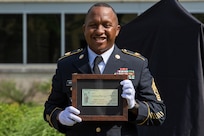 Recently retired Sgt. Maj. Ronald Houston, U.S. Army Financial Management Command Operations senior enlisted advisor, poses with a voided U.S. Treasury check during his retirement ceremony at the Maj. Gen. Emmett J. Bean Federal Center in Indianapolis July 17, 2020. The voided check, not worth any monetary value, was made out for $1 million and was presented on behalf to of the Defense Finance and Accounting Service director with a note on it that said, “Thanks a million!” (U.S. Army photo by Mark R. W. Orders-Woempner)