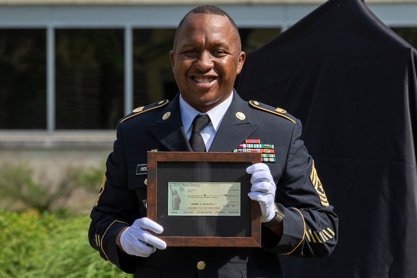 Recently retired Sgt. Maj. Ronald Houston, U.S. Army Financial Management Command Operations senior enlisted advisor, poses with a voided U.S. Treasury check during his retirement ceremony at the Maj. Gen. Emmett J. Bean Federal Center in Indianapolis July 17, 2020. The voided check, not worth any monetary value, was made out for $1 million and was presented on behalf to of the Defense Finance and Accounting Service director with a note on it that said, “Thanks a million!” (U.S. Army photo by Mark R. W. Orders-Woempner)