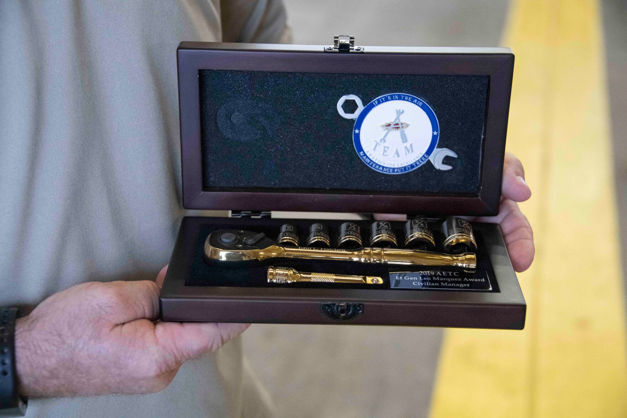 award is held by hands