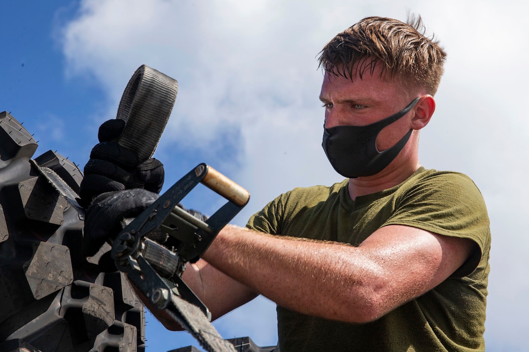 A Marine wears a face mask as he works.