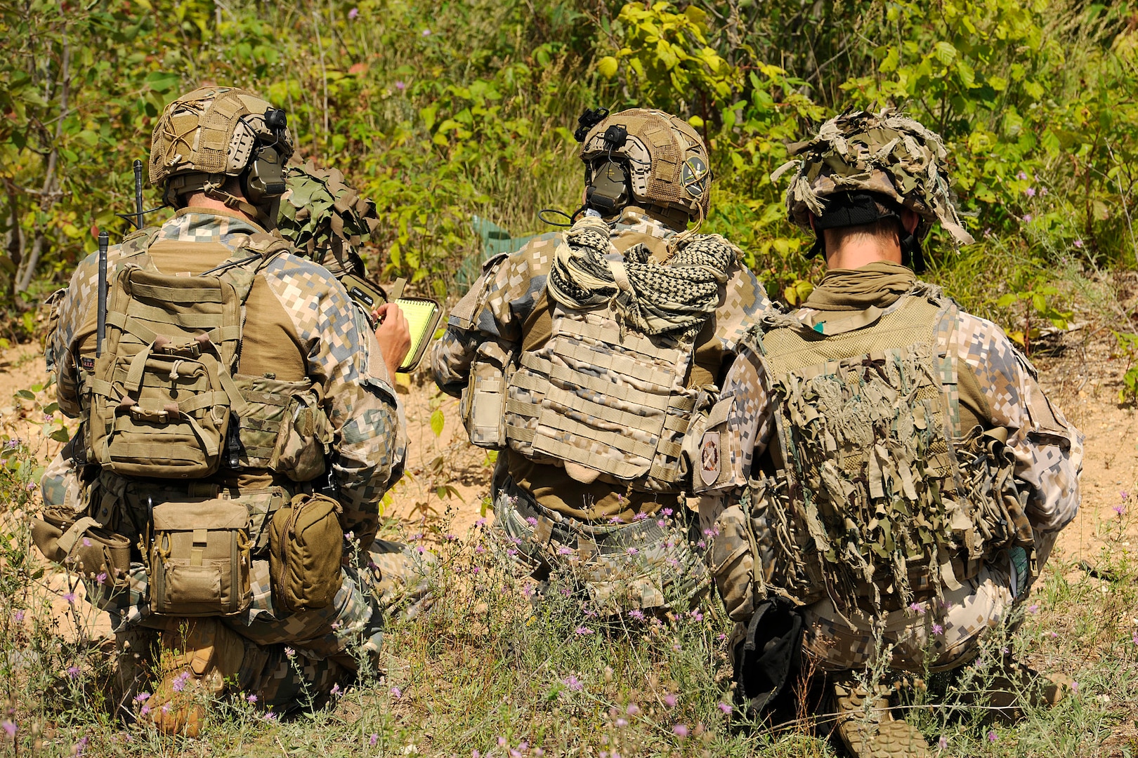 A team of Joint Terminal Attack Controllers (JTACs) from the Latvian National Armed Forces, look over the terrain while conducting close air support training during Northern Strike 20 at Camp Grayling, part of the National All-Domain Warfighting Center in Northern Michigan during Northern Strike 20, July 28, 2020.