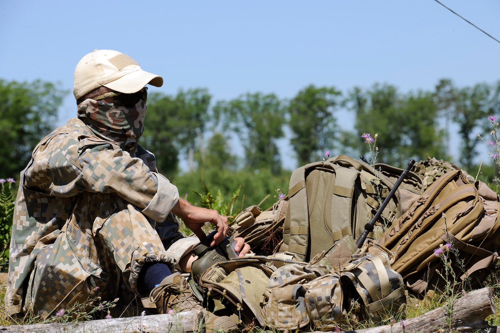 Joint Terminal Attack Controllers (JTACs) from the Latvian National Armed Forces, look over the terrain while conducting close air support training at Camp Grayling, part of the National All-Domain Warfighting Center in Northern Michigan during Northern Strike 20, July 24, 2020.