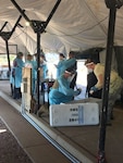 Colorado National Guard members, prepare a COVID-19 testing site in Canon City, Colorado, July 29, 2020. The CONG is using Mobile Testing and Training teams to assist the Colorado Department of Public Health & Environment with ongoing COVID-19 testing across Colorado. (Courtesy photo)