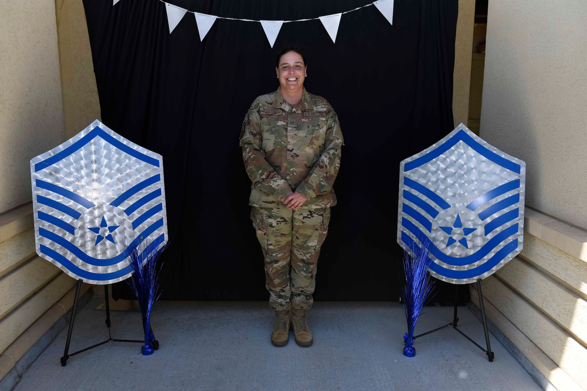 U.S. Air Force Tech. Sgt. Kari Pohlschneider, 60th Operations Support Squadron superintendent of wing intelligence, stands in a photo booth during a master sergeant release celebration July 23, 2020, at Travis Air Force Base, California. The event coordinators created a photo booth for master sergeant selects and their families to take photos. (U.S. Air Force photo by Airman 1st Class Cameron Otte)