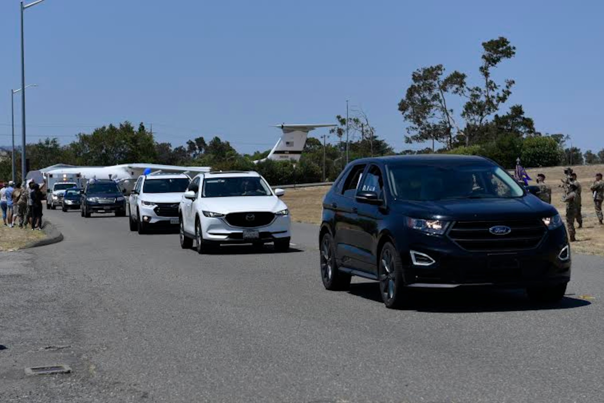 Master sergeant selects drive their cars in a parade during a promotion celebration July 23, 2020, at Travis Air Force Base, California. Travis AFB Airmen selected for promotion to master sergeant celebrated by participating in a parade in order to adhere to COVID-19 social distancing guidelines. (U.S. Air Force photo by Airman 1st Class Cameron Otte)
