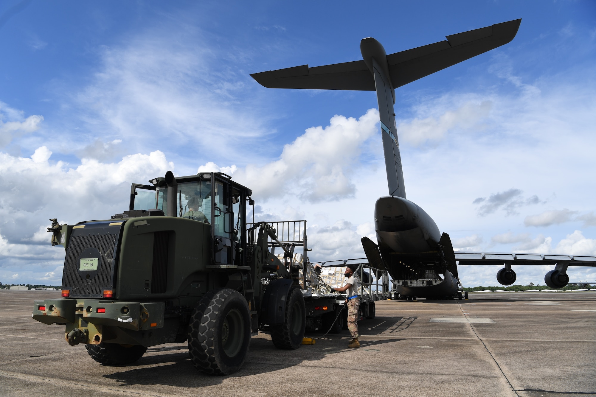 Aerial Porters from the 321st Contingency Response Squadron, prepare to load cargo onto a C-5 Galaxy during exercise Swamp Devil at Lake Charles, Louisiana, July 27, 2020. Exercise Swamp Devil will evaluate the 621st Contingency Response Wing’s ability to provide humanitarian aid and disaster relief following a Category 4 hurricane. (U.S. Air Force photo by Tech. Sgt. Luther Mitchell Jr)