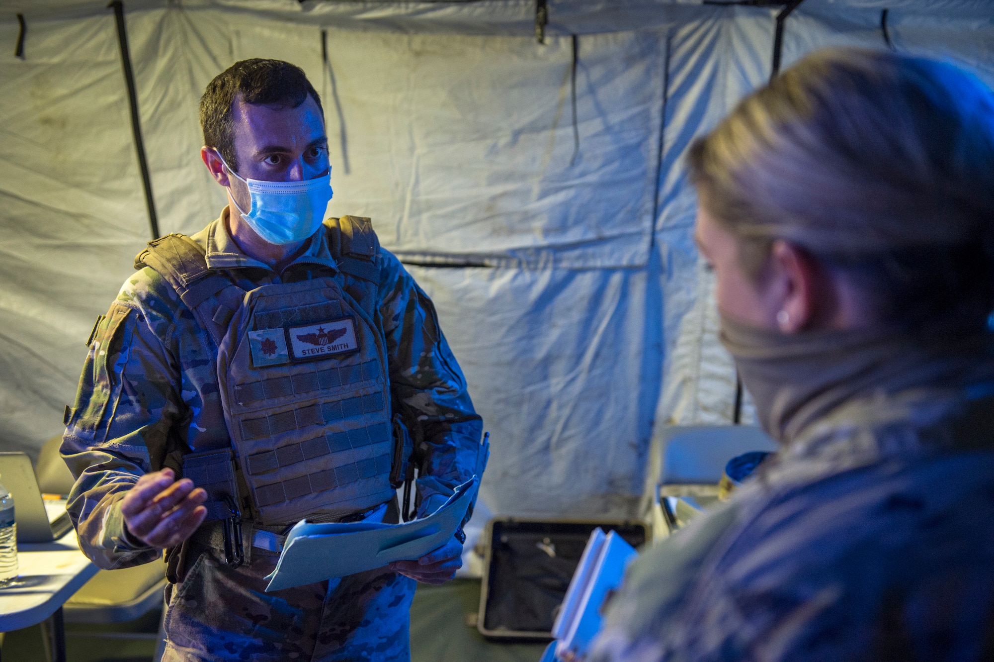 Maj. Steve Smith, 621st Contingency Response Squadron operations officer, responds to an exercise inject involving COVID-19 mitigation measures as part of Exercise Swamp Devil July 29, 2020, at Alexandria International Airport, Louisiana. The exercise tested the CR forces’ ability to respond to a Category 4 hurricane and provide humanitarian assistance and disaster relief  in a COVID-19 environment. (U.S. Air Force photo by Staff Sgt. Sarah Brice)