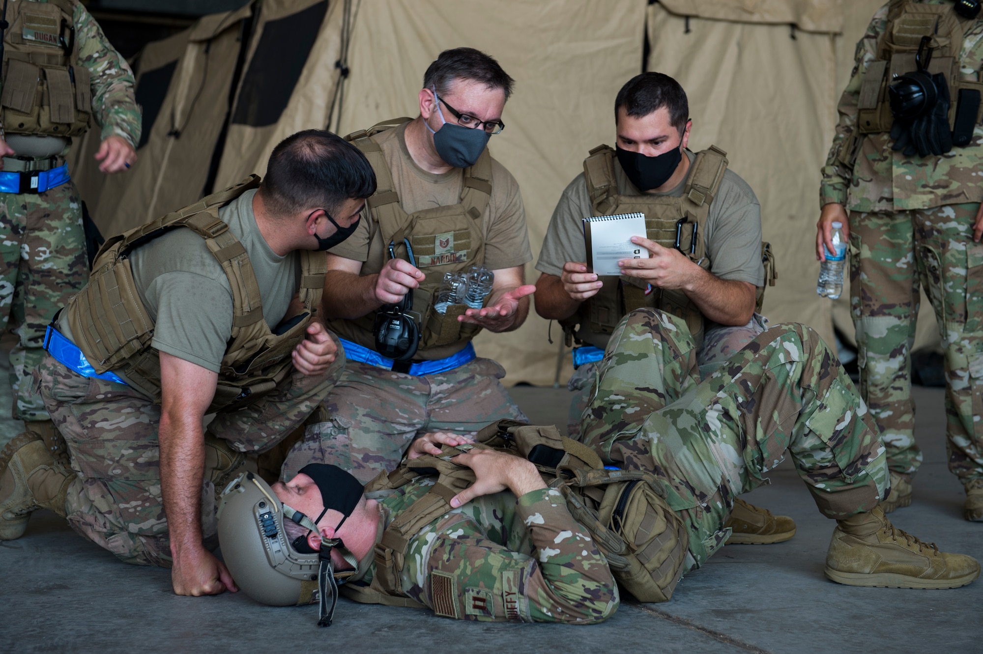 Airmen from the 621st Contingency Response Wing respond to an exercise inject involving a simulanted injured member as part of Exercise Swamp Devil July 29, 2020, at Alexandria International Airport, Louisianaa. The exercise tested the CR forces’ ability to respond to a Category 4 hurricane and provide humanitarian assistance and disaster relief in a COVID-19 environment. (U.S. Air Force photo by Staff Sgt. Sarah Brice)