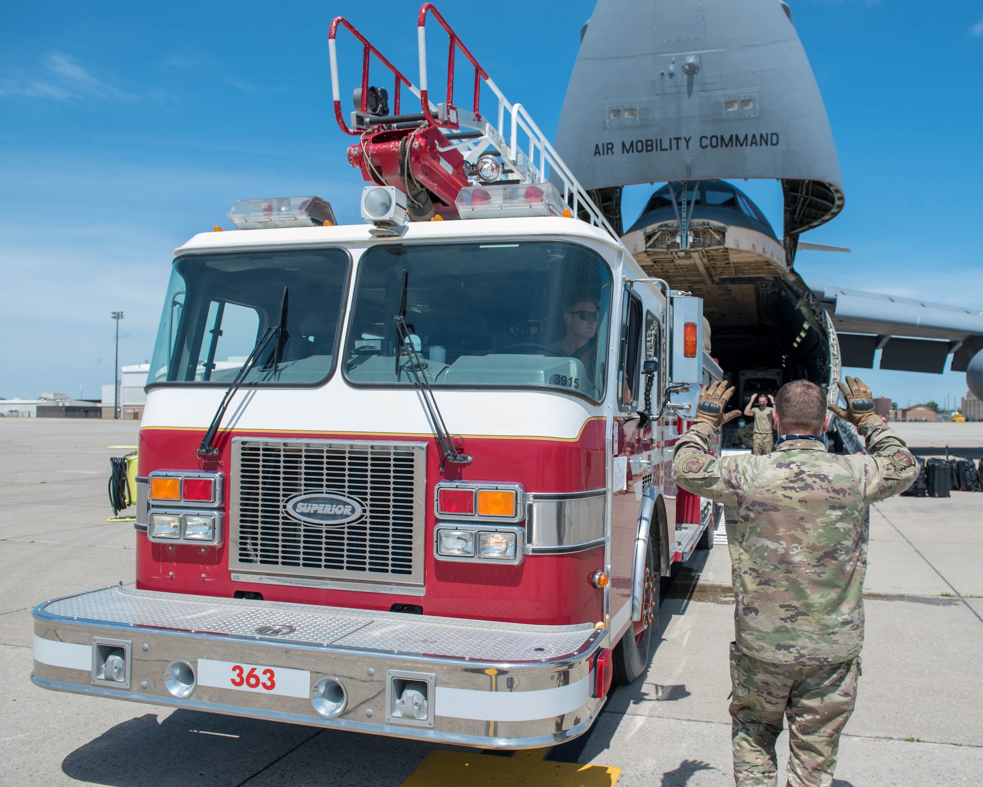 Members of the 30th Aerial Port Squadron, Niagara Falls Air Reserve Station N.Y. and 22nd Airlift Squadron, Travis, Air Force Base, Calif. prepare to load a fire truck inside a C-5 Galaxy aircraft at Niagara Falls ARS on July 25, 2020.  The donated fire truck from Canada and two ambulances will end their long journey in Nicaragua. (U.S. Air Force photo by Peter Borys)