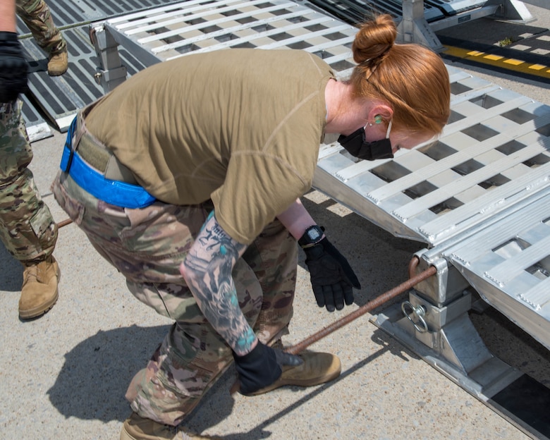 U.S. Air Force Tech. Sgt. Holly Witte, 30th Aerial Port Squadron air terminal operations center representative, helps secure a ramp outside a C-5M Super Galaxy July 25, 2020, at Niagara Falls Air Reserve Station, New York. The ramp is used to load large vehicles and heavy equipment. Witte assisted with the loading of a fire truck, ambulance and supplies bound for Nicaragua in support of a Denton Program mission. (U.S. Air Force photo by Peter Borys)