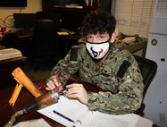 Torpedoman’s Mate Third Class Craig Figgins, Code 950, performs a resistance check on a counter measure cable for the Virginia class submarine, USS New Hampshire (SSN 778).