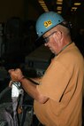 Shop 38’s Outside Machinist Loren Nelson Boulanger prepares a high data rate antenna for transport to the Virginia class submarine USS Washington (SSN 787).