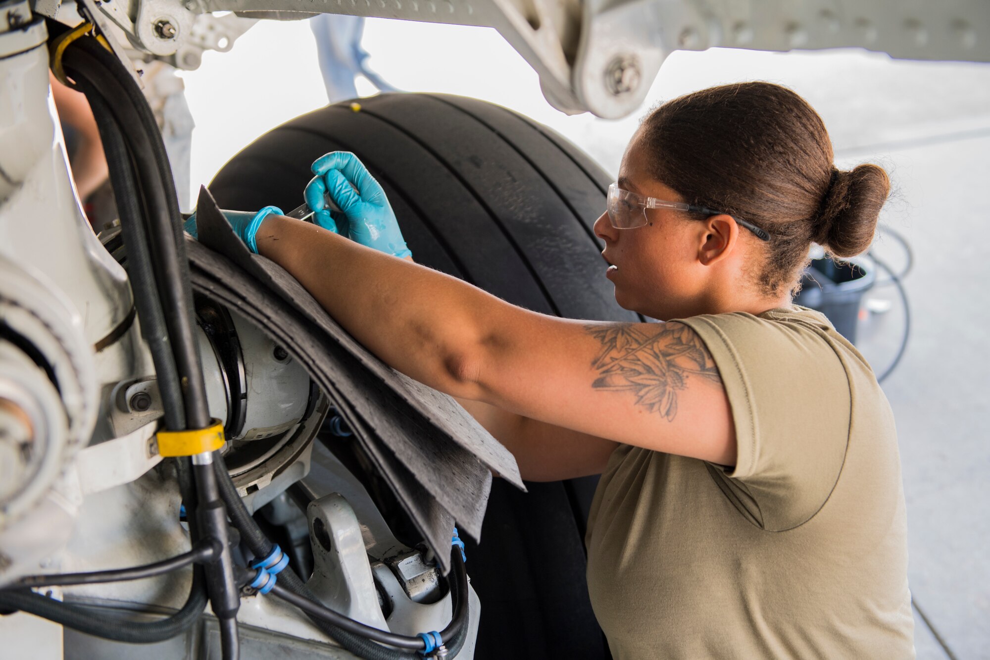 Senior Airman Kendra Ancell, 911th Aircraft Maintenance Squadron hydraulics technician, drains hydraulic fluid from the main landing gear strut of a C-17 Globemaster III at the Pittsburgh International Airport Air Reserve Station, Pennsylvania, June 20, 2020.