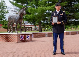 Maj. Adam Kama, deputy judge advocate, 1st Theater Sustainment Command, stands in front of Fowler Hall as the recipient of the Keithe E. Nelson Distinguished Service Award at Ft. Knox, Kentucky, July 28, 2020. According to the American Bar Association’s website, the award is presented for authorship of exceptional, published, literary efforts which advance and serve interests and understanding of military law or enhance status of lawyers in the Armed Forces. (U.S. Army photo by Spc. JC Baker, 1st TSC Public Affairs)