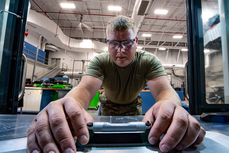 Staff Sgt. Adam Kitta, 911th Maintenance Squadron metals technology specialist, ensures a piece of metal is level before working on it at the Pittsburgh International Airport Air Reserve Station, Pennsylvania, July 8, 2020.