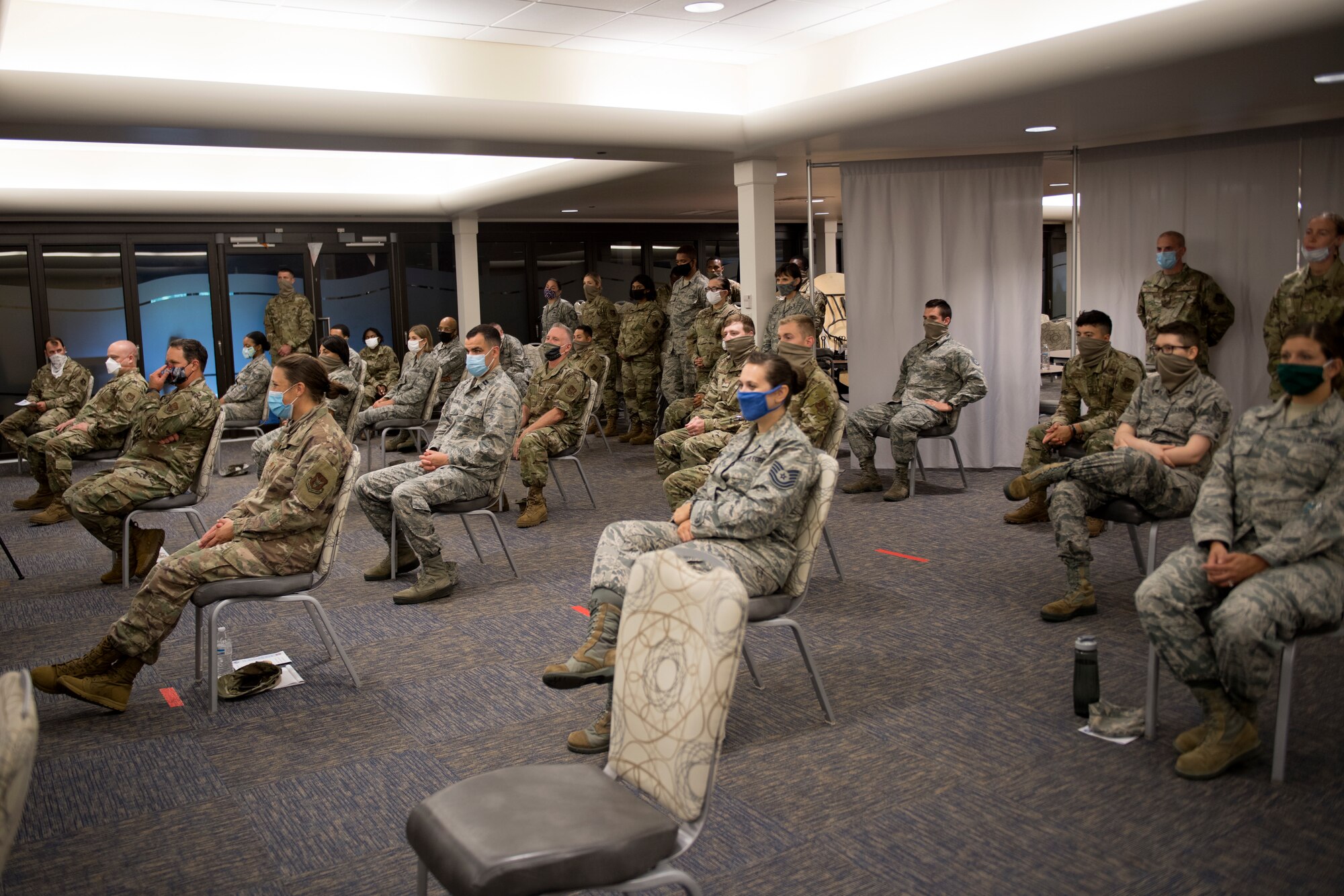 Members of the 911th Airlift Wing sit and listen to Maj. Sabrina Ocampo, commander of the 911th Force Support Squadron, during her assumption of command ceremony at the Pittsburgh International Airport Air Reserve Station. Pennsylvania, July 12, 2020.