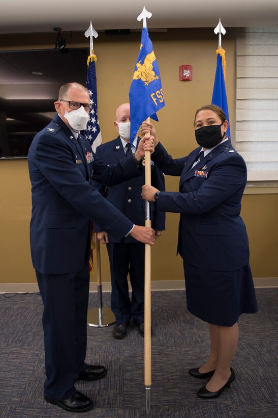 Maj. Sabrina Ocampo, commander of the 911th Force Support Squadron, accepts the 911th FSS guidon from Col. Kenneth M. Lute, commander of the 911th Mission Support Group, during an assumption of command ceremony at the Pittsburgh International Airport Air Reserve Station. Pennsylvania, July 12, 2020.