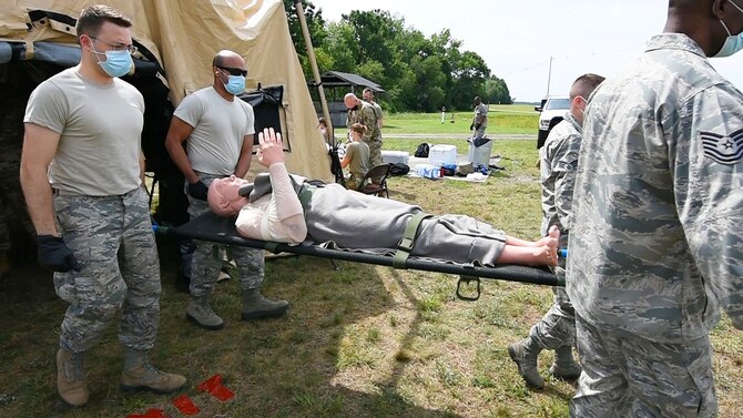 Members of the 439th Aerospace Staging Squadron practice liter carries at Westover Air Reserve Base, Massachusetts on July 24, 2020. The 39th ASTS, 439th Aeromedical Evacuation Squadron and 42nd Aerial Port Squadron conducted a multi-day exercise where they ran through deployment scenarios and medical care. (U.S. Air Force photo by Tech. Sgt. Shane Phipps)
