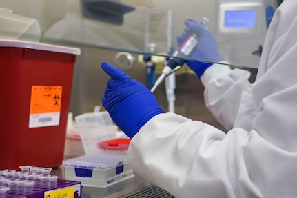 A lab technician with the Naval Health Research Center processes specimens for COVID-19 testing, March 19, 2020.