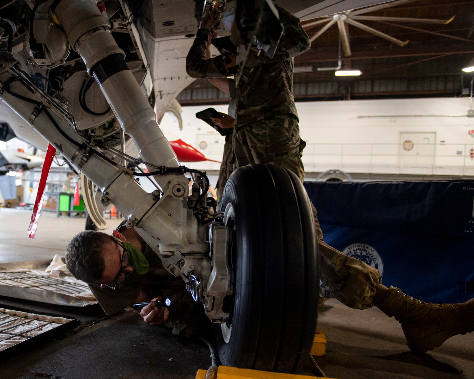 Airman check brakes on F-16