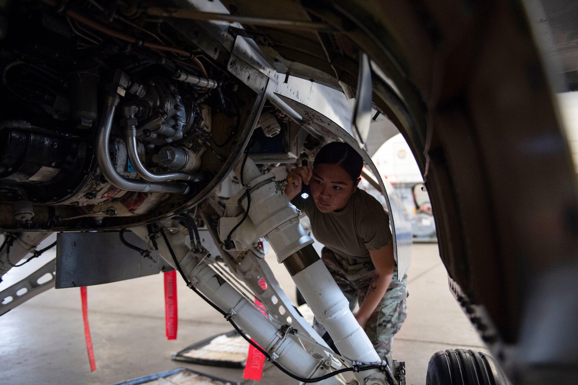 Airman performs maintenance check on F-16