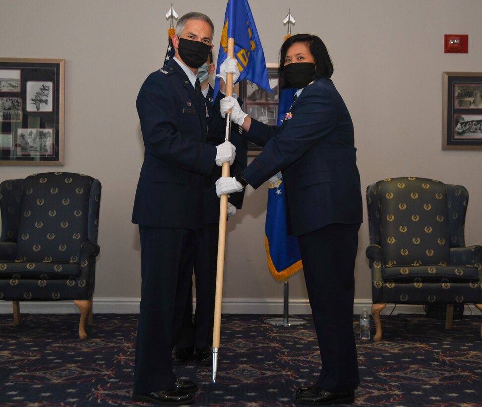 Col. Jason J. Lennen, 316th Medical Group commander, passes the guidon to Lt. Col. Marie-Antonette C. Brancato, who assumes command of the 316th Medical Squadron during a change of command ceremony at Joint Base Anacostia-Bolling, Washington, D.C., July 29, 2020.