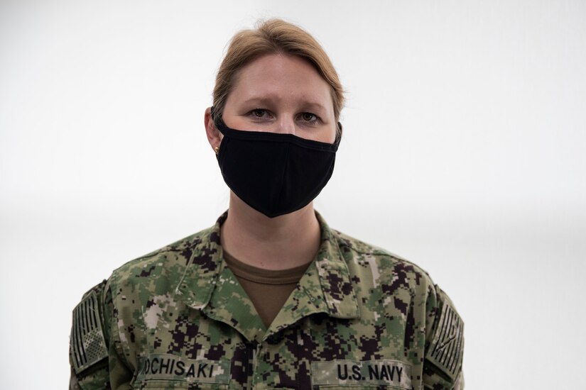 A sailor poses for a photo.