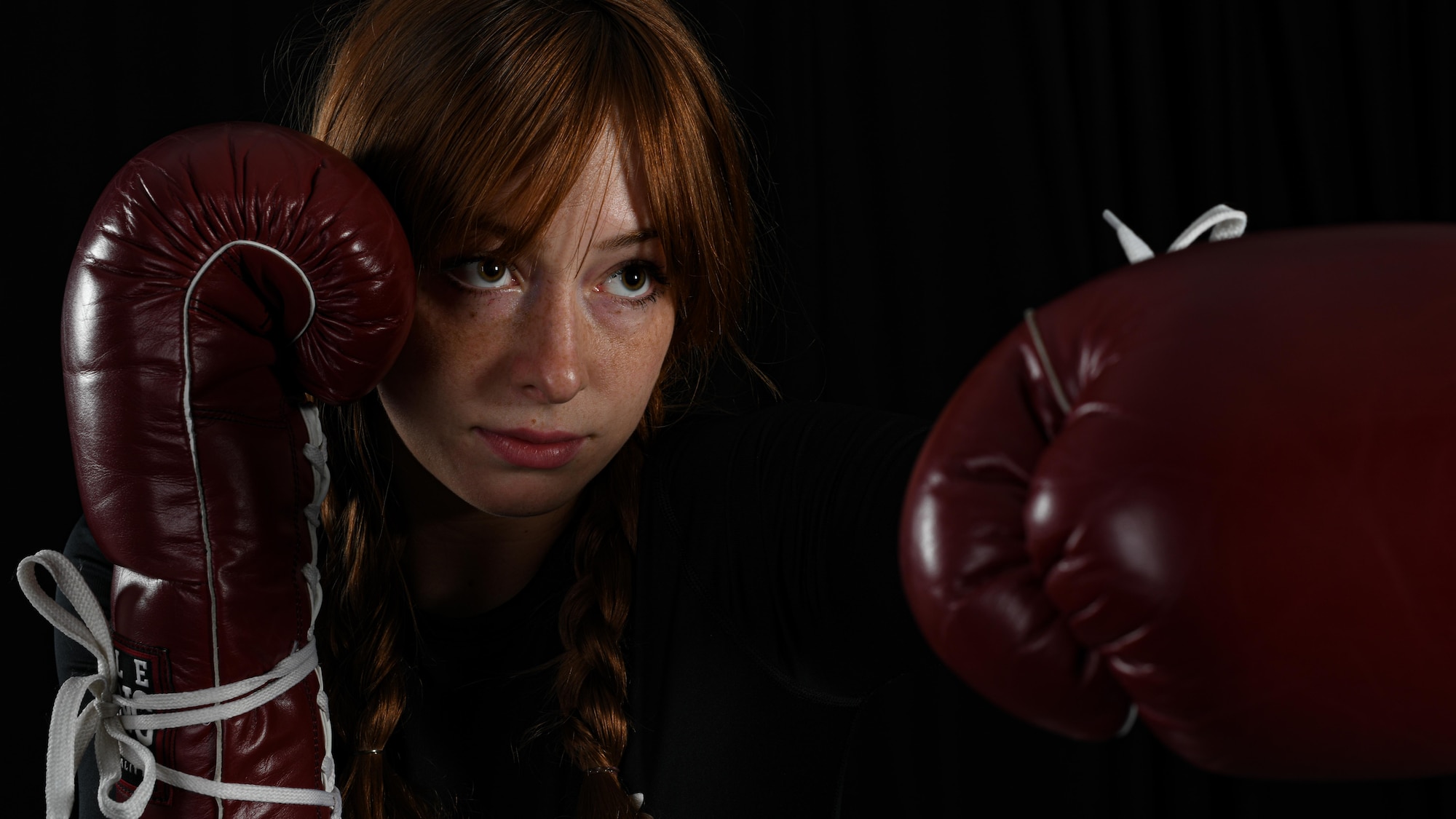 Senior Airman Sarah Jane Gruber, a broadcast journalist for the 910th Public Affairs Office, poses for a photo in her boxing attire, July 11, 2020, Youngstown Air Reserve Station. Gruber competes in Women’s Amateur Boxing for USA Boxing’s Great Lakes Region and has trained in boxing for four years.