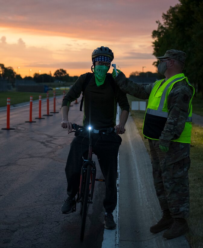 Airmen check temperatures at a COVID-19 prescreening station.