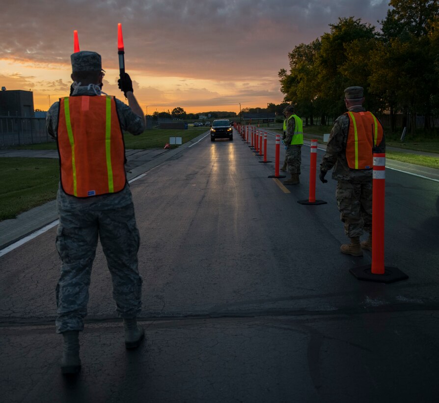 Airmen check temperatures at a COVID-19 prescreening station.