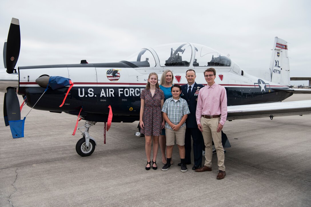 Col. Craig D. Prather, 47th Flying Training Wing commander, and his family stand in front of a T-6 Texan II before the virtual wing change of command ceremony at Laughlin Air Force Base, Texas, July 31, 2020. Prather takes command after serving as the commander of the 1st Joint Special Operations Air Component at Fort Bragg, N.C. (U.S. Air Force photo by Senior Airman Marco A. Gomez)