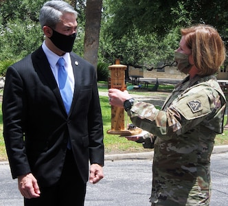 Lt. Gen. Laura J. Richardson (right), commanding general of U.S. Army North (Fifth Army) and the Joint Force Land Component Command, presents San Antonio Mayor Ron Nirenberg with a replica of the historic Fort Sam Houston Quadrangle during his visit to Fort Sam Houston July 29. U.S. Army North leaders were able to update City of San Antonio officials on their day-to-day mission, as well as the response against the COVID-19 pandemic, which includes hospitals across San Antonio.
