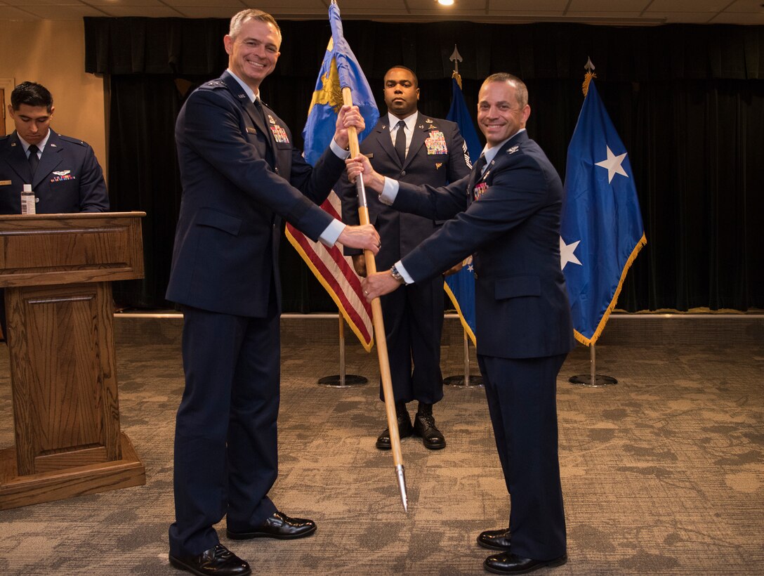 Maj. Gen. Craig Wills, 19th Air Force commander, receives the guidon from Col. Lee Gentile, 47th Flying Training Wing commander, during the virtual wing change of command ceremony at Laughlin Air Force Base, Texas, July 31, 2020. The ceremony was held through a virtual livestream to accommodate necessary precautions due to COVID-19. (U.S. Air Force photo by Senior Airman Marco A. Gomez)