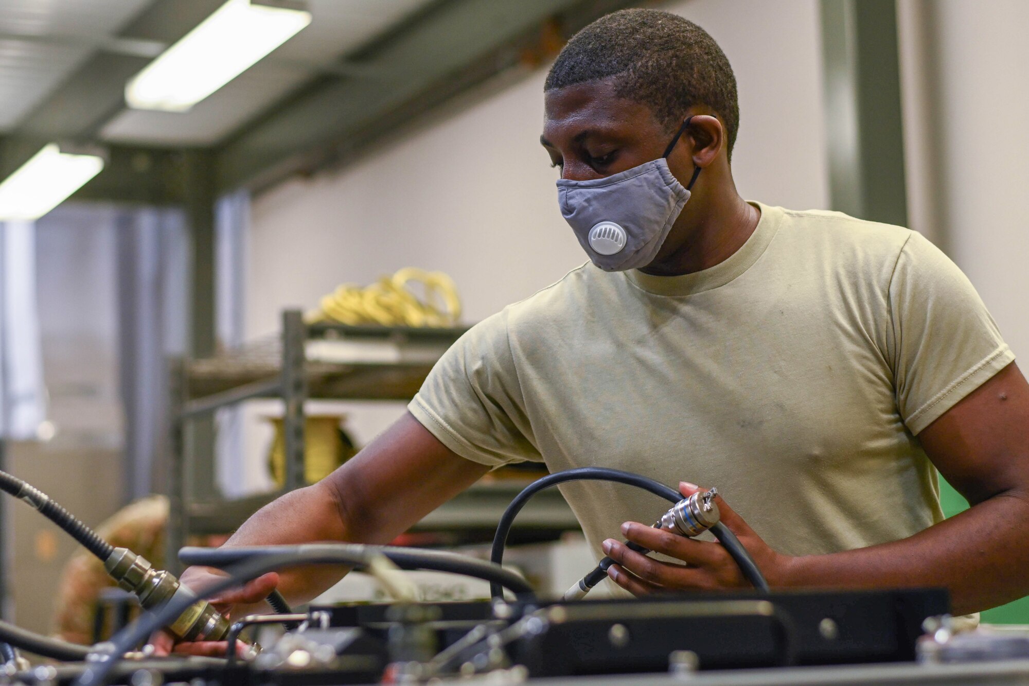 An airman prepares a munition for testing.
