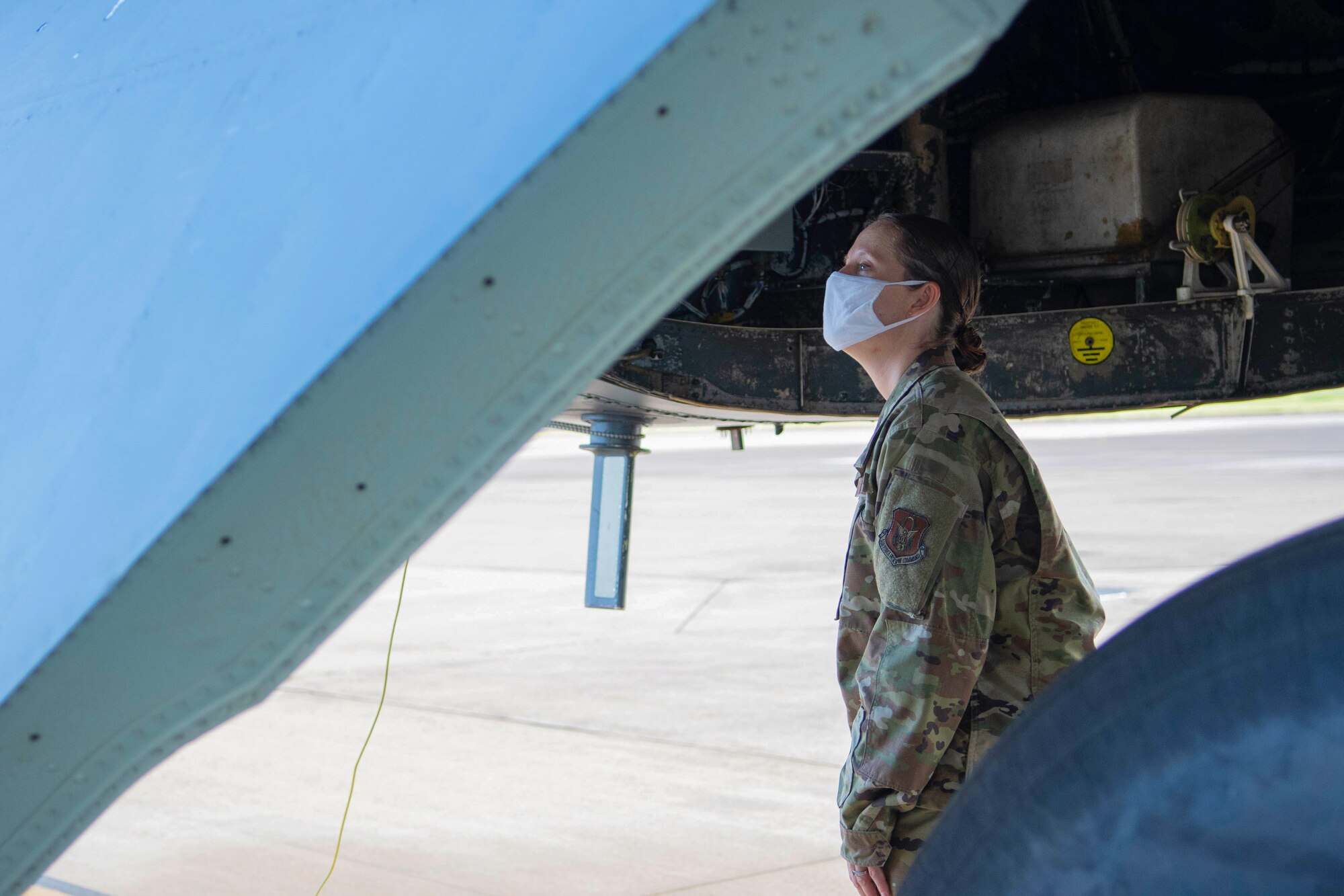 Photo of Airman looking in wheel well of a B-52.