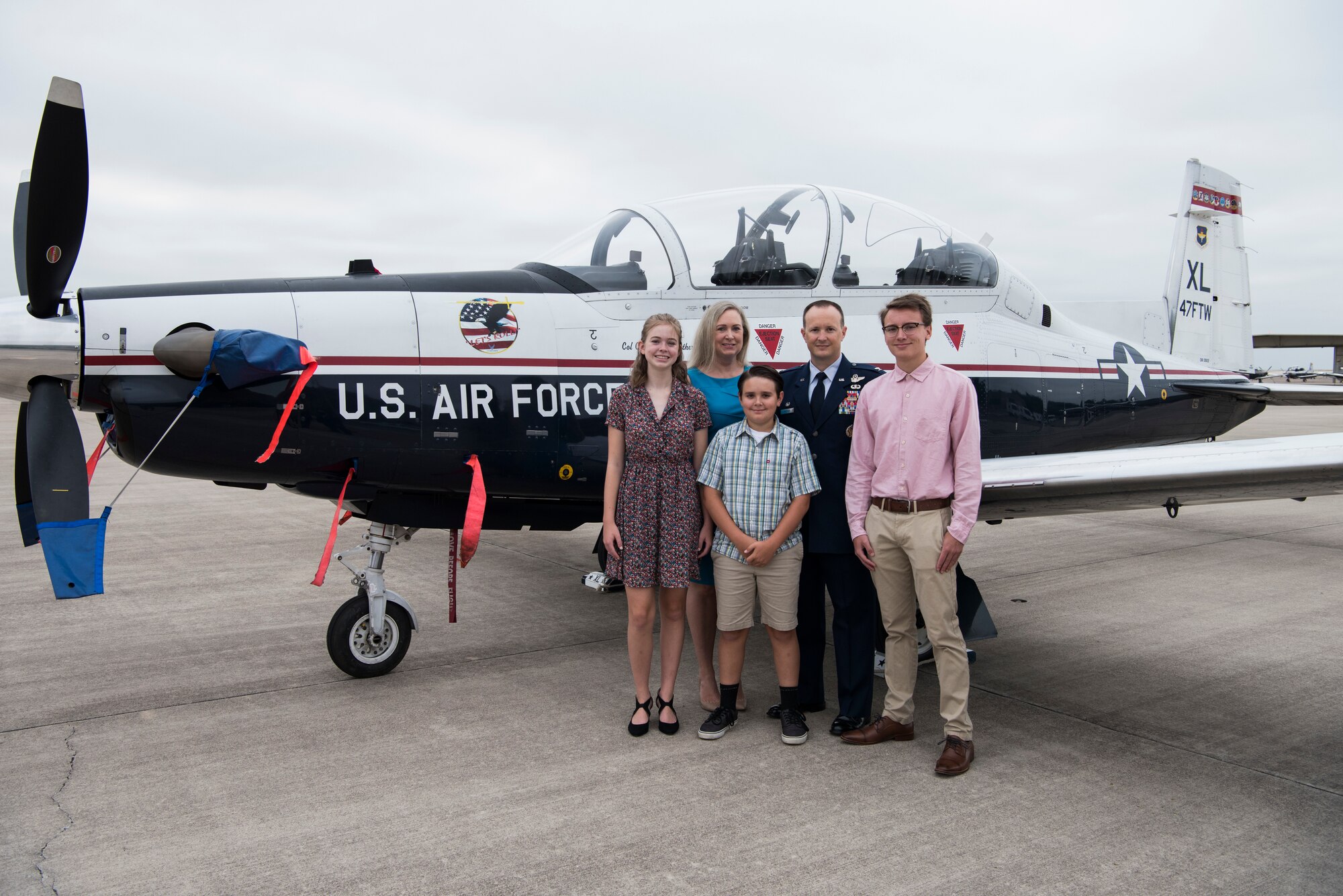 Col. Craig D. Prather, 47th Flying Training Wing commander, and his family stand in front of a T-6 Texan II before the virtual wing change of command ceremony at Laughlin Air Force Base, Texas, July 31, 2020. Prather takes command after serving as the commander of the 1st Joint Special Operations Air Component at Fort Bragg, N.C. (U.S. Air Force photo by Senior Airman Marco A. Gomez)