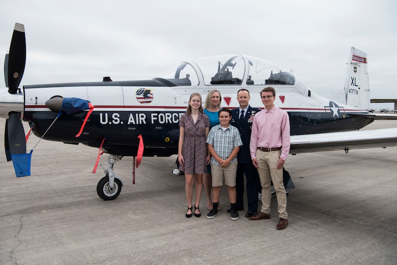 Col. Craig D. Prather, 47th Flying Training Wing commander, and his family stand in front of a T-6 Texan II before the virtual wing change of command ceremony at Laughlin Air Force Base, Texas, July 31, 2020. Prather takes command after serving as the commander of the 1st Joint Special Operations Air Component at Fort Bragg, N.C. (U.S. Air Force photo by Senior Airman Marco A. Gomez)