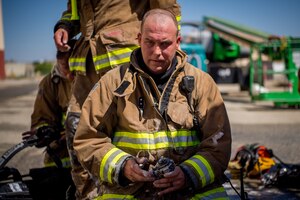 Firefighter John Templeton takes a break following search and rescue training at a recently remodeled hangar at Edwards Air Force Base, California, July 23. Firefighters were tasked locating a simulated victim amidst the fire suppressant foam deployed throughout the hangar. (Air Force photo by Chris Dyer)