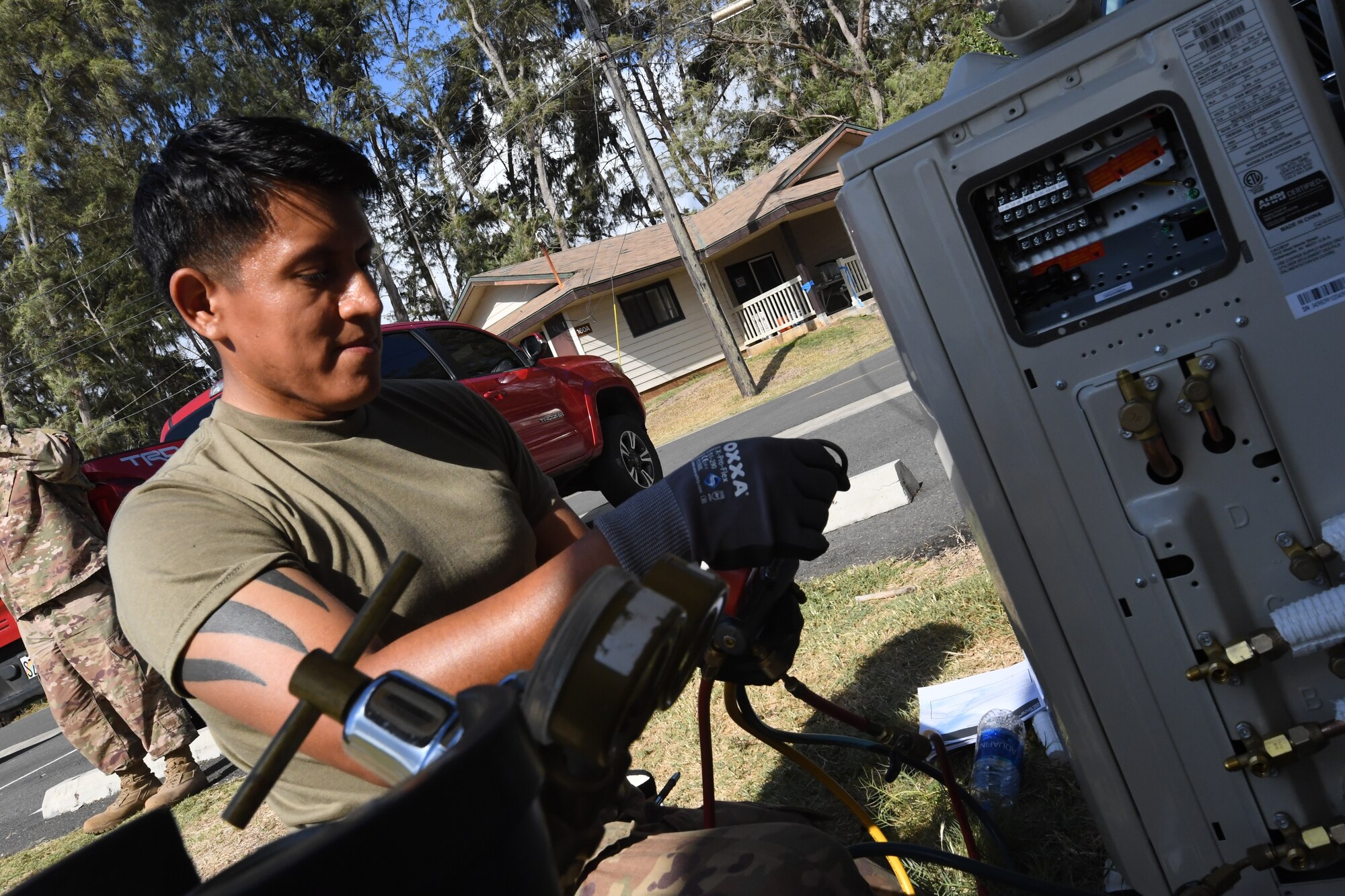A photo of U.S. Air Force Tech. Sergeant Andre Chamilco, 624th Civil Engineer Squadron Heating Ventilation and Air Conditioning, repairing a local unit for facility repairs at Bellows Air Force Station, Hawaii, July 22, 2020, during the unit’s Annual Training. The U.S. Air Force Reserve’s 624th CES provided necessary repairs at Bellows AFS, a Military Welfare and Recreation facility that supports military families and communities, to improve infrastructure and increase individual readiness skills. (U.S. Air Force photo by Tech. Sgt. Garrett Cole)