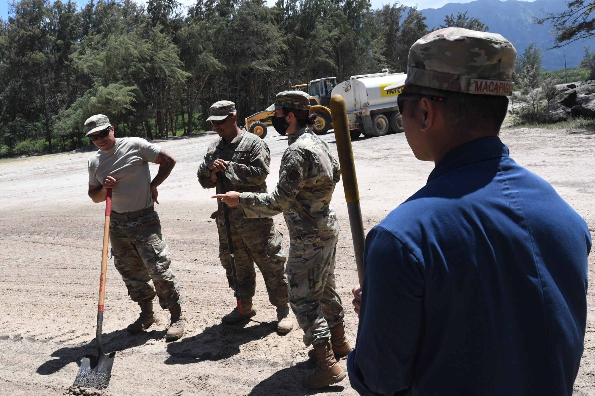 A photo of U.S. Air Force Col. Athanasia Shinas, 624th Regional Support commander, discussing the importance of readiness training with 624th Civil Engineer Squadron Airmen as they provide facility repairs at Bellows Air Force Station, Hawaii, July 22, 2020, during the unit’s Annual Training. The U.S. Air Force Reserve’s 624th CES provided necessary repairs at Bellows AFS, a Military Welfare and Recreation facility that supports military families and communities, to improve infrastructure and increase individual readiness skills. (U.S. Air Force photo by Tech. Sgt. Garrett Cole)